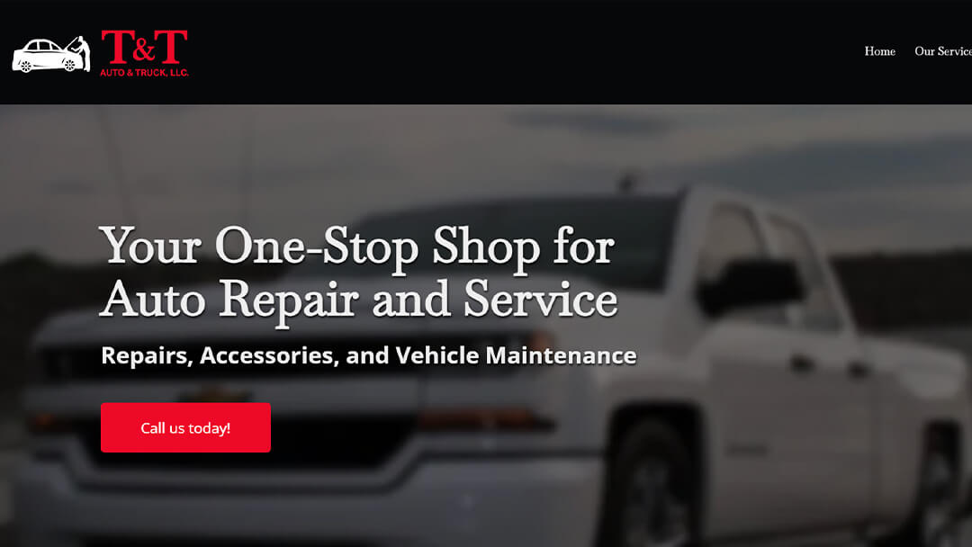 A white pickup truck in front of the T&T Auto & Truck LLC shop, featured on their website. The image promotes their comprehensive auto repair and service offerings, highlighting their status as a one-stop shop for repairs, accessories, and vehicle maintenance.