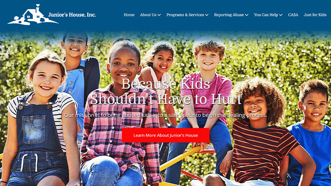 A group of happy children of various ages and backgrounds sit together on playground equipment, showcasing joy and friendship. The image is part of Junior's House, Inc.'s website, which aims to provide a safe space for abused children to start their healing journey.