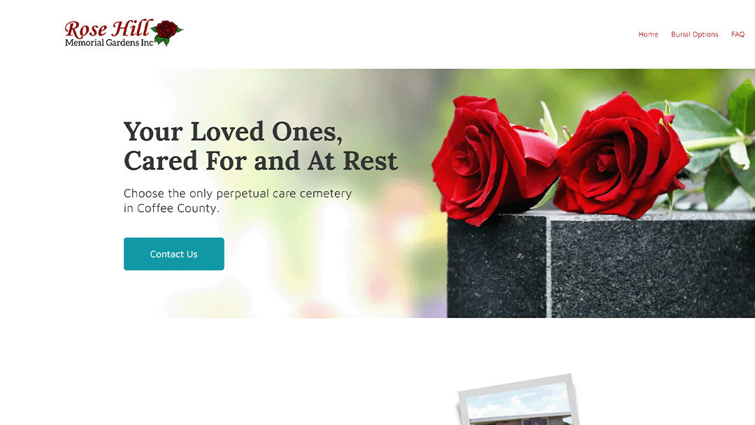 Image of two red roses resting on a gravestone with the text 