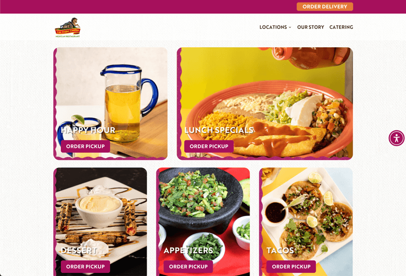 A smiling man in glasses and a light blue shirt working on a laptop at a desk in a modern office, indicating a positive and focused work atmosphere.