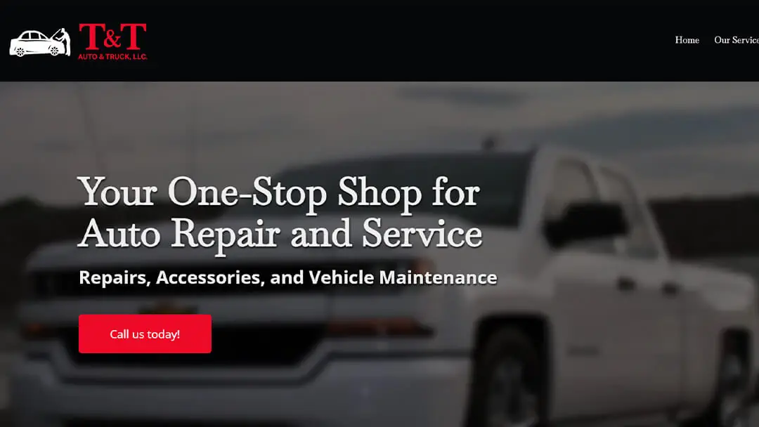 A white pickup truck in front of the T&T Auto & Truck LLC shop, featured on their website. The image promotes their comprehensive auto repair and service offerings, highlighting their status as a one-stop shop for repairs, accessories, and vehicle maintenance.
